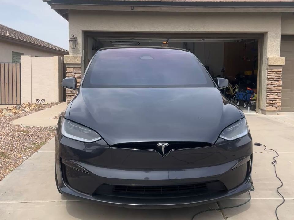 The same Tesla Model X after a ZnA detail — deep black gloss, spotless paint